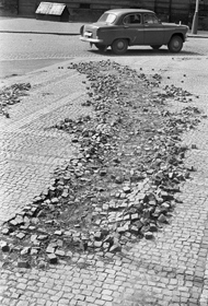 Dlažba chodníku vytrhaná pásy sovětského tanku. Léto 1968