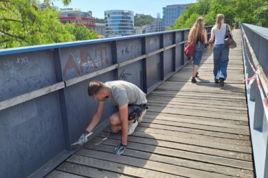 Odstraňování čmáranic z lávky, která spojuje park Sacre Coeur a nákupní centrum Nový Smíchov. 